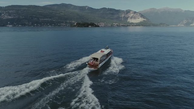 Passenger ship voyage on the mountain Italy lake, drone 4k nature flight