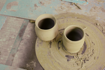 the unfinished brown earthen pots on pedestal sculpt