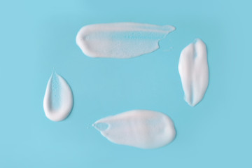 Soap foam bubbles on blue background macro close up.