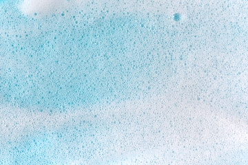 Soap foam bubbles on blue background macro close up. - obrazy, fototapety, plakaty