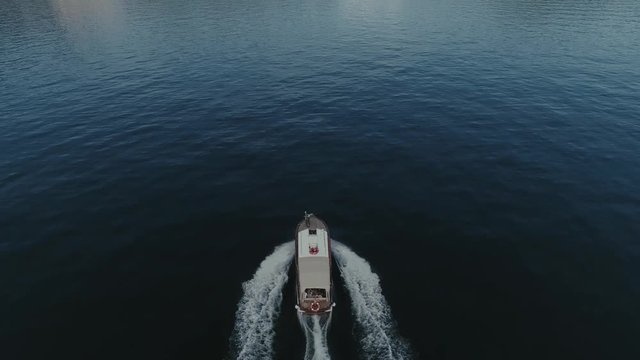Passenger ship voyage on the mountain Italy lake, drone 4k nature flight