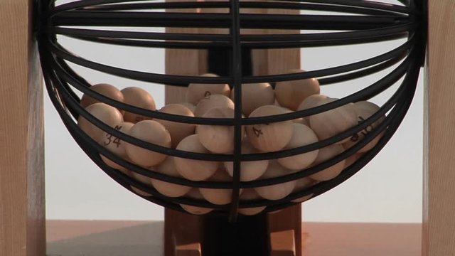Close-up of bingo balls spinning in a bingo cage.