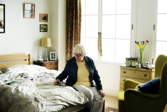 Senior woman sitting on bed