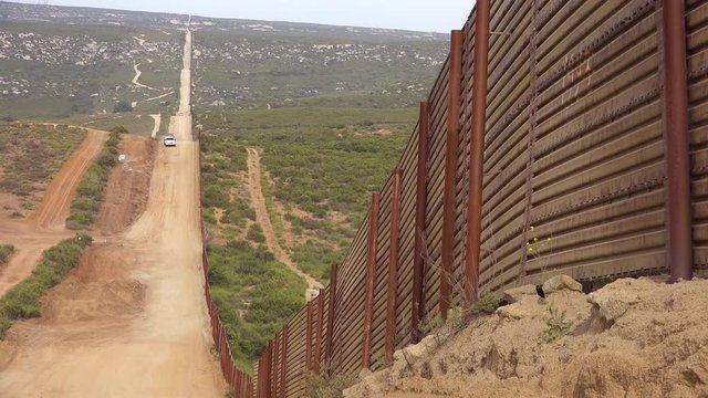 Border patrol vehicle standing guard near the border wall at the US Mexico border at Nogales, Arizona.