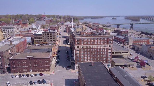 Rising aerial shot over small town America Burlington Iowa downtown with Mississippi River background.