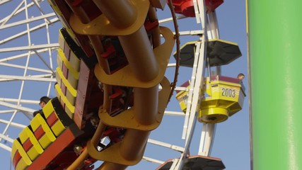 Close up of a Ferris wheel and a roller coaster