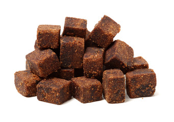 brown cubes of sugar on white background