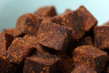 brown cubes of sugar on white background