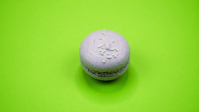 ROTATION: A Colorful Macaroons are rotating on a green background