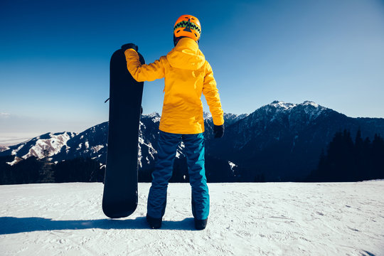 One snowboarder ready for snowboarding on winter mountain top