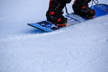 one snowboarder snowboarding in winter mountains