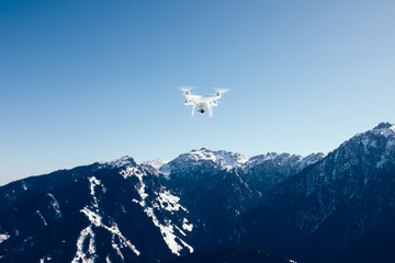 drone flying  over winter mountain top