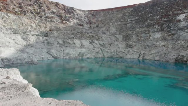 Panoramic view of a lake at the bottom of a quarry