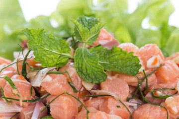 Salmon spicy salad with lemon grass isolated on white background