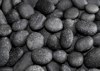 Texture of dried round gray river stone background