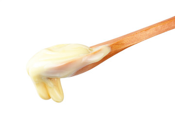 Condensed Milk in wooden spoon
