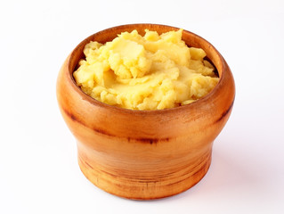 mashed potatoes in wooden bowl on table with spices
