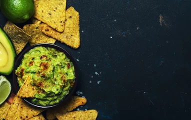 Fotobehang Mexican food, guacamole sauce with avocado, onion, garlic and chili, black background, top view © 5ph