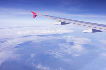 Obraz premium plane wing flying over blue sky white cloud