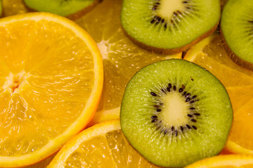 Naklejka na ściany i meble Background of the kiwi and orange fruits