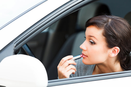 Pretty woman driver doing makeup