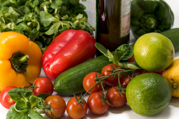 Fototapeta na wymiar fresh raw vegetables, salad preparation, pepper, tomatoes, cucumber, fresh salad, lime, lemon, cheese