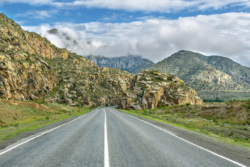 road mountains asphalt clouds