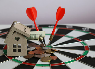 Target Success,saving concepts with house , dolar and coins on the dart . Real estate and mortgage