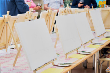 Canvases, brushes, palettes on the table ready for the art studio masterclass