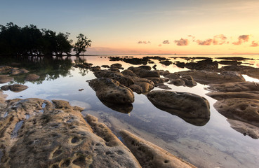 Sunset seascape with natural coastal rocks  at Kudat, Sabah Malaysia.