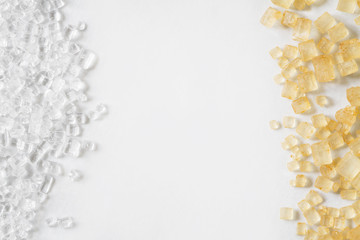 Closeup of white and brown sugar on the light background with the copy space