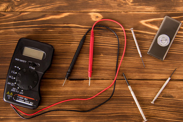 A set for the repair of electronic equipment on a dark wooden background
