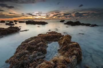 Sunset seascape with natural coastal rocks  at Kudat, Sabah Malaysia.