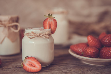 Organic yougurt in jar with strawberry. Fresh strawberry with yogurt