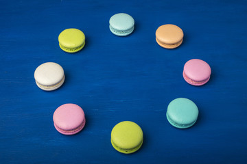 Colorful cookies. Cake macaron or macaroon on a blue background. Copy space 2