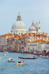 Fototapeta na wymiar Basilica Santa Maria della Salute, Venice, Italy. Landscape Grand Canal with gondolas and boats.