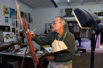 Painter artist painting a picture in the studio