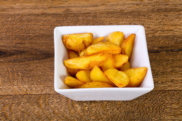 Rustic potato over wooden background