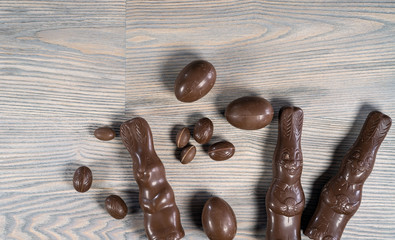 Delicious chocolate easter eggs ,bunny and sweets on dark wood background