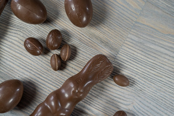 Delicious chocolate easter eggs ,bunny and sweets on dark wood background