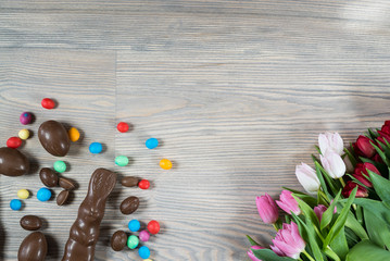 Delicious chocolate easter eggs ,bunny and sweets on dark wood background