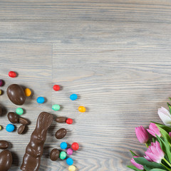 Fototapeta na wymiar Delicious chocolate easter eggs ,bunny and sweets on dark wood background