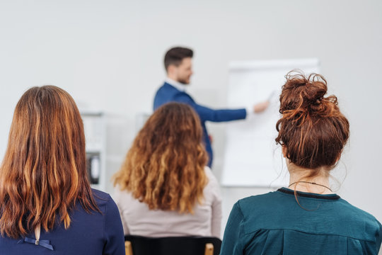 Group of businesswomen listening to a presentation