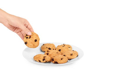 Pile of chocolate chip cookies on a dish in hand isolated on white background. copy space, template