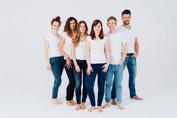 Fototapeta premium Group of casual students posing together barefoot