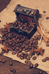 Coffee beans in a trunk, buckwheat and cinnamon sticks.