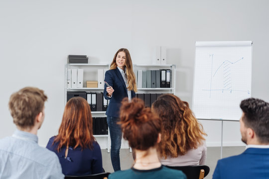 Businesswoman lecturing to a group of colleagues