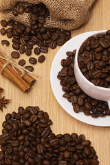 Coffee beans and ground coffee. Heart made of coffee beans. Toning.