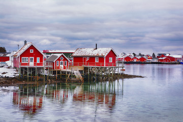 Beautiful winter landscape with traditional Norwegian fishing huts in Lofoten islands - obrazy, fototapety, plakaty