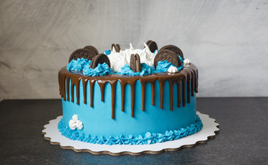 bright blue cream cake with sweets and cookies